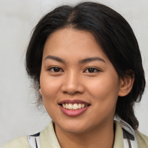 Joyful asian young-adult female with medium  brown hair and brown eyes