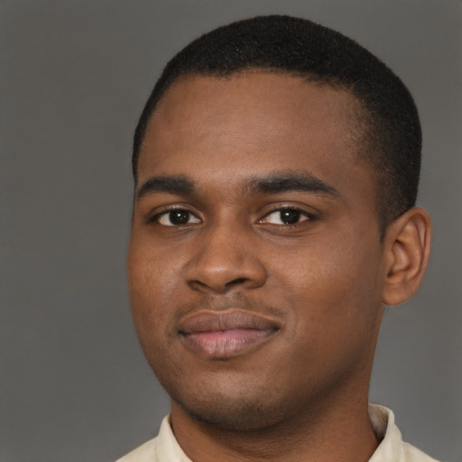 Joyful black young-adult male with short  brown hair and brown eyes