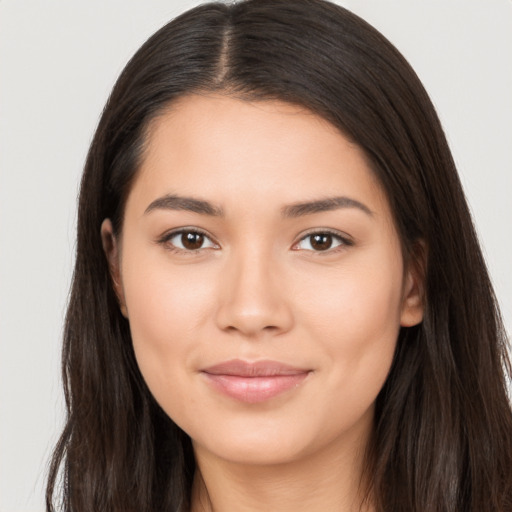 Joyful latino young-adult female with long  brown hair and brown eyes