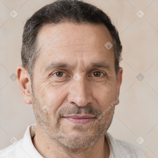 Joyful white adult male with short  brown hair and brown eyes