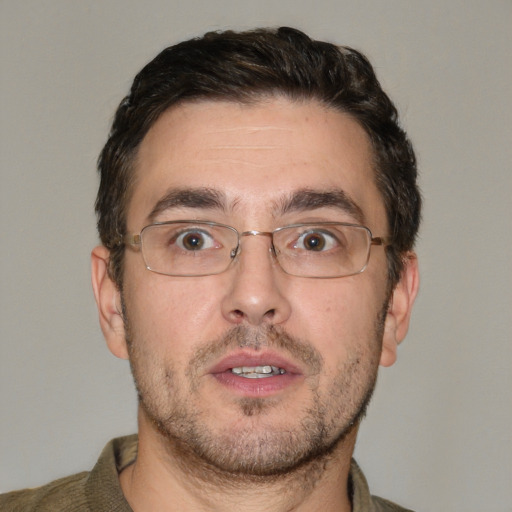 Joyful white adult male with short  brown hair and brown eyes