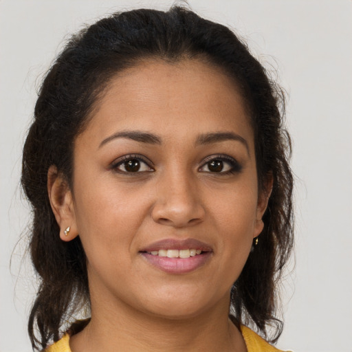 Joyful latino young-adult female with medium  brown hair and brown eyes