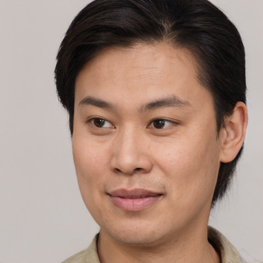 Joyful latino young-adult male with short  brown hair and brown eyes
