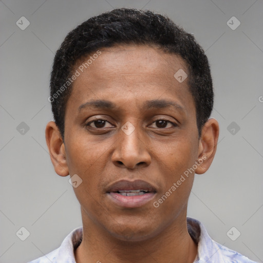 Joyful latino young-adult male with short  brown hair and brown eyes
