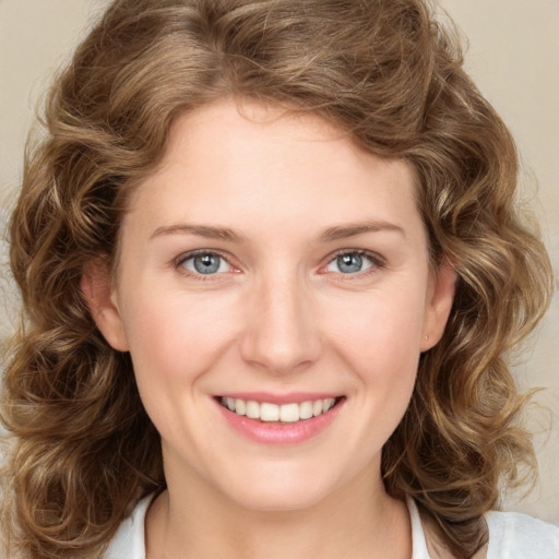 Joyful white young-adult female with medium  brown hair and green eyes