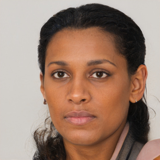 Neutral black young-adult female with long  brown hair and brown eyes