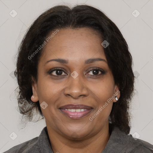 Joyful black adult female with medium  brown hair and brown eyes