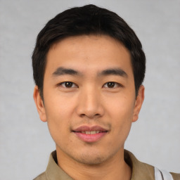 Joyful asian young-adult male with short  black hair and brown eyes