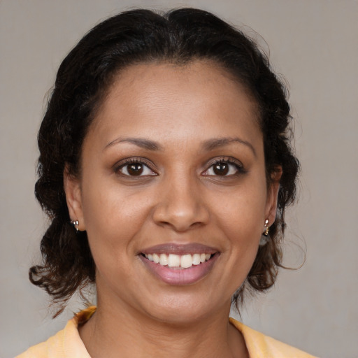 Joyful latino young-adult female with medium  brown hair and brown eyes