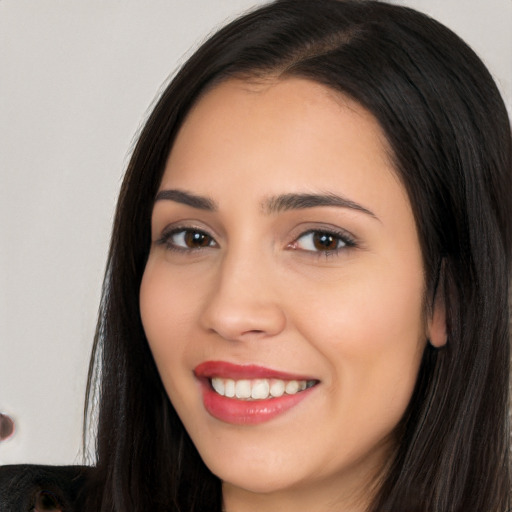 Joyful white young-adult female with long  black hair and brown eyes