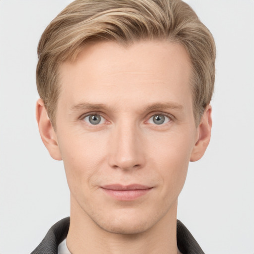 Joyful white young-adult male with short  brown hair and grey eyes