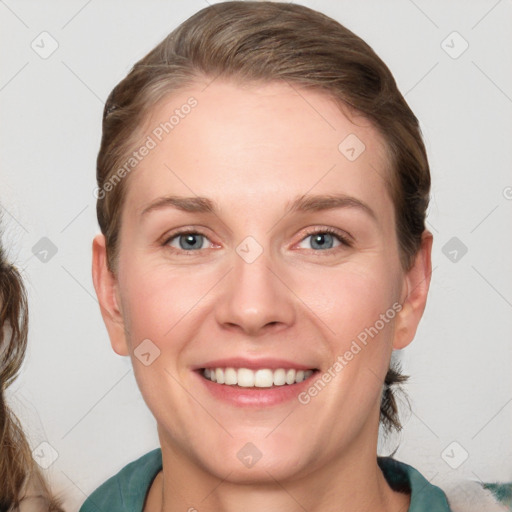 Joyful white young-adult female with medium  brown hair and blue eyes