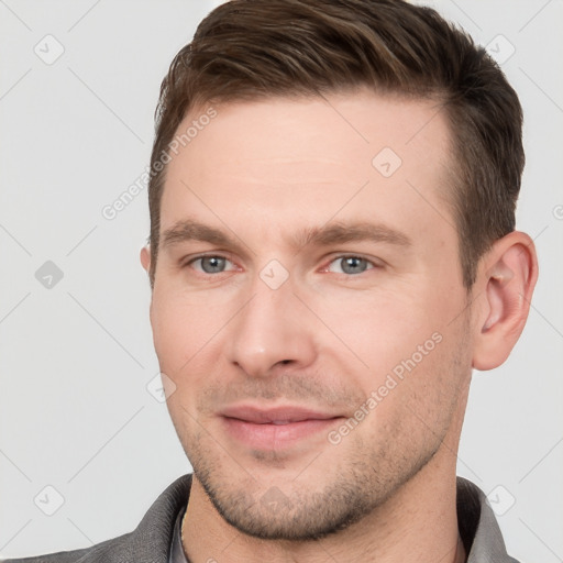 Joyful white young-adult male with short  brown hair and grey eyes