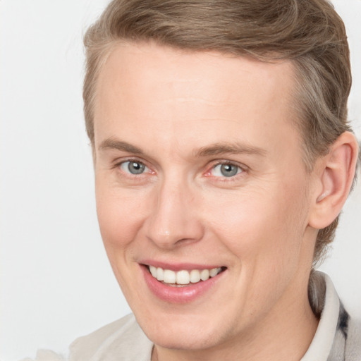 Joyful white adult female with short  brown hair and grey eyes