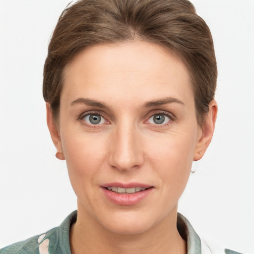 Joyful white young-adult female with short  brown hair and grey eyes