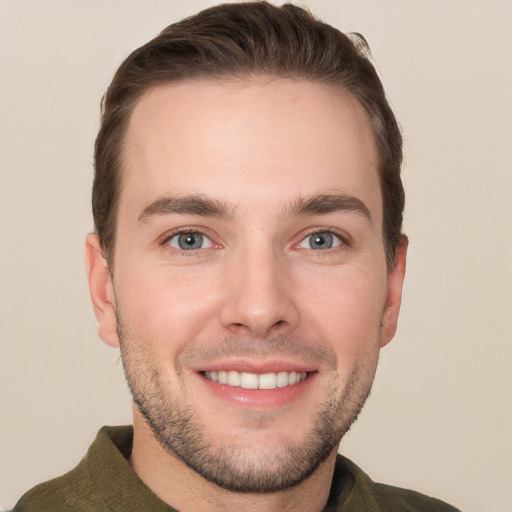 Joyful white young-adult male with short  brown hair and grey eyes