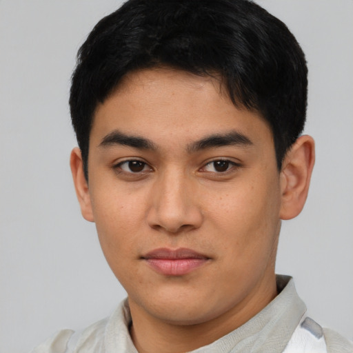 Joyful asian young-adult male with short  brown hair and brown eyes