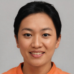 Joyful asian young-adult female with short  black hair and brown eyes