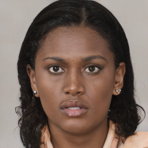Neutral black young-adult female with medium  brown hair and brown eyes