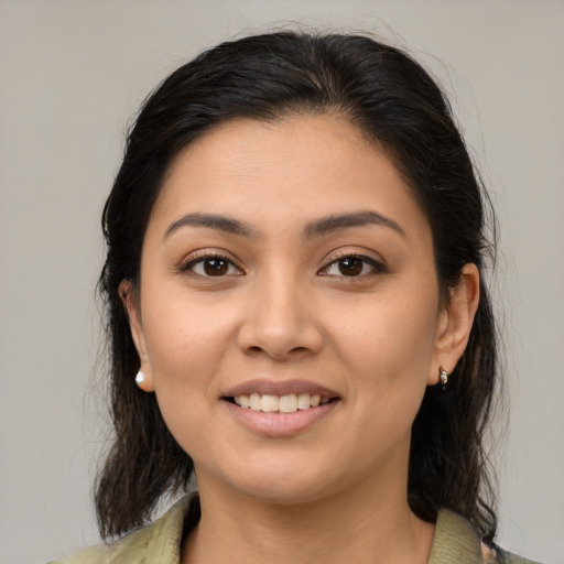 Joyful latino young-adult female with medium  brown hair and brown eyes