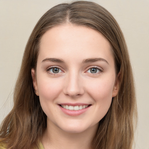 Joyful white young-adult female with long  brown hair and green eyes