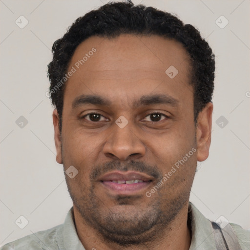 Joyful latino adult male with short  black hair and brown eyes