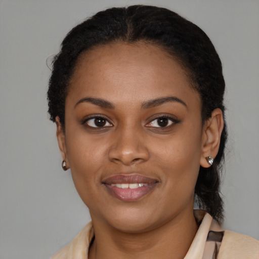 Joyful black young-adult female with short  brown hair and brown eyes