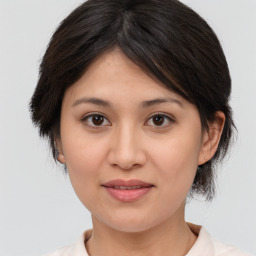 Joyful asian young-adult female with medium  brown hair and brown eyes