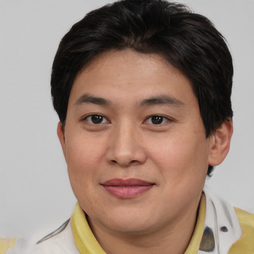 Joyful asian young-adult male with short  brown hair and brown eyes