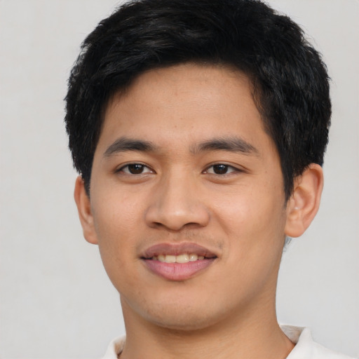 Joyful asian young-adult male with short  black hair and brown eyes