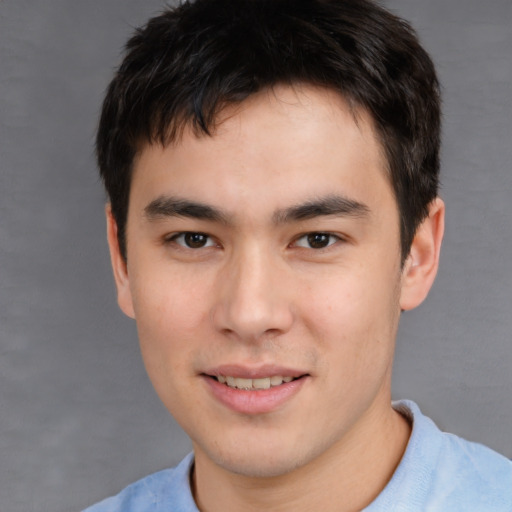 Joyful asian young-adult male with short  brown hair and brown eyes