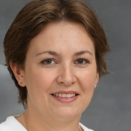 Joyful white adult female with medium  brown hair and brown eyes