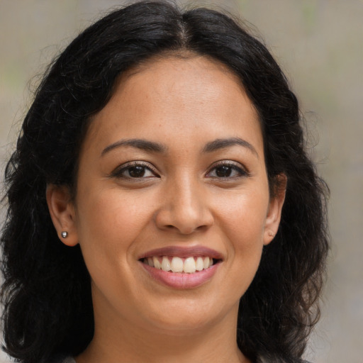 Joyful latino young-adult female with long  brown hair and brown eyes