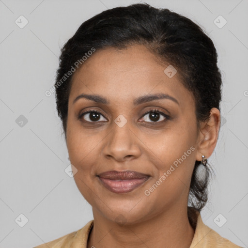 Joyful black adult female with medium  brown hair and brown eyes