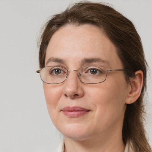 Joyful white adult female with medium  brown hair and grey eyes