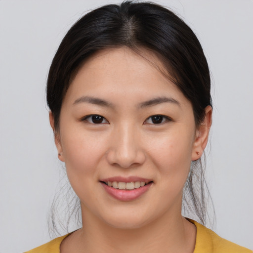 Joyful asian young-adult female with medium  brown hair and brown eyes