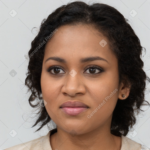 Joyful black young-adult female with long  brown hair and brown eyes