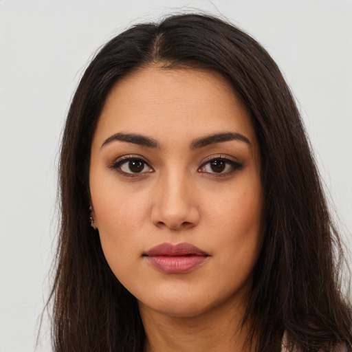 Neutral latino young-adult female with long  brown hair and brown eyes