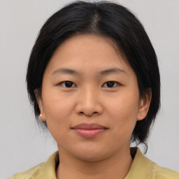 Joyful asian young-adult female with medium  brown hair and brown eyes