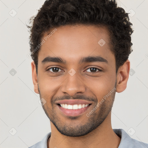 Joyful black young-adult male with short  brown hair and brown eyes