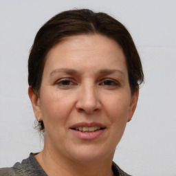 Joyful white adult female with short  brown hair and grey eyes