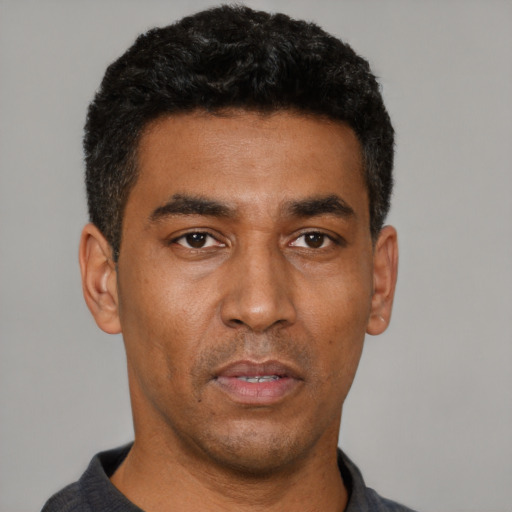 Neutral latino adult male with short  black hair and brown eyes