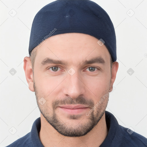 Joyful white young-adult male with short  black hair and brown eyes