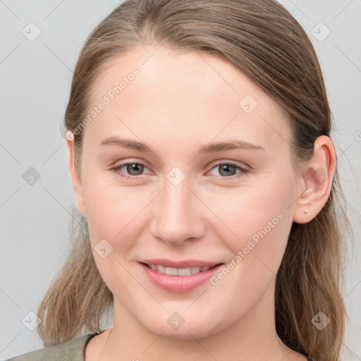 Joyful white young-adult female with long  brown hair and grey eyes