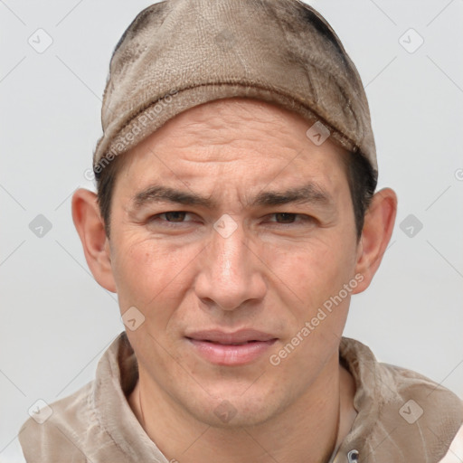 Joyful white adult male with short  brown hair and grey eyes