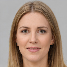 Joyful white young-adult female with long  brown hair and green eyes