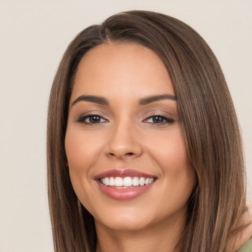 Joyful white young-adult female with long  brown hair and brown eyes