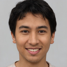 Joyful asian young-adult male with short  brown hair and brown eyes