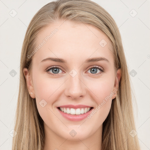 Joyful white young-adult female with long  brown hair and blue eyes