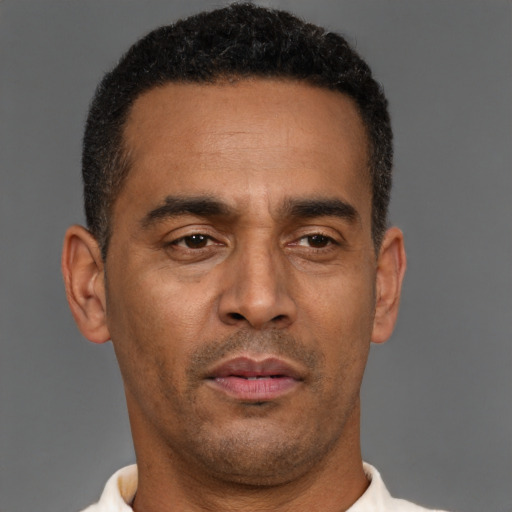 Neutral latino adult male with short  brown hair and brown eyes